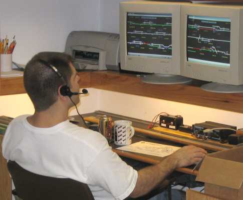 Scott Kurzawski at the APN dispatchers desk. That CTC display on the screens is software written by Scott, and allows control of the layout thru the C/MRI interface.